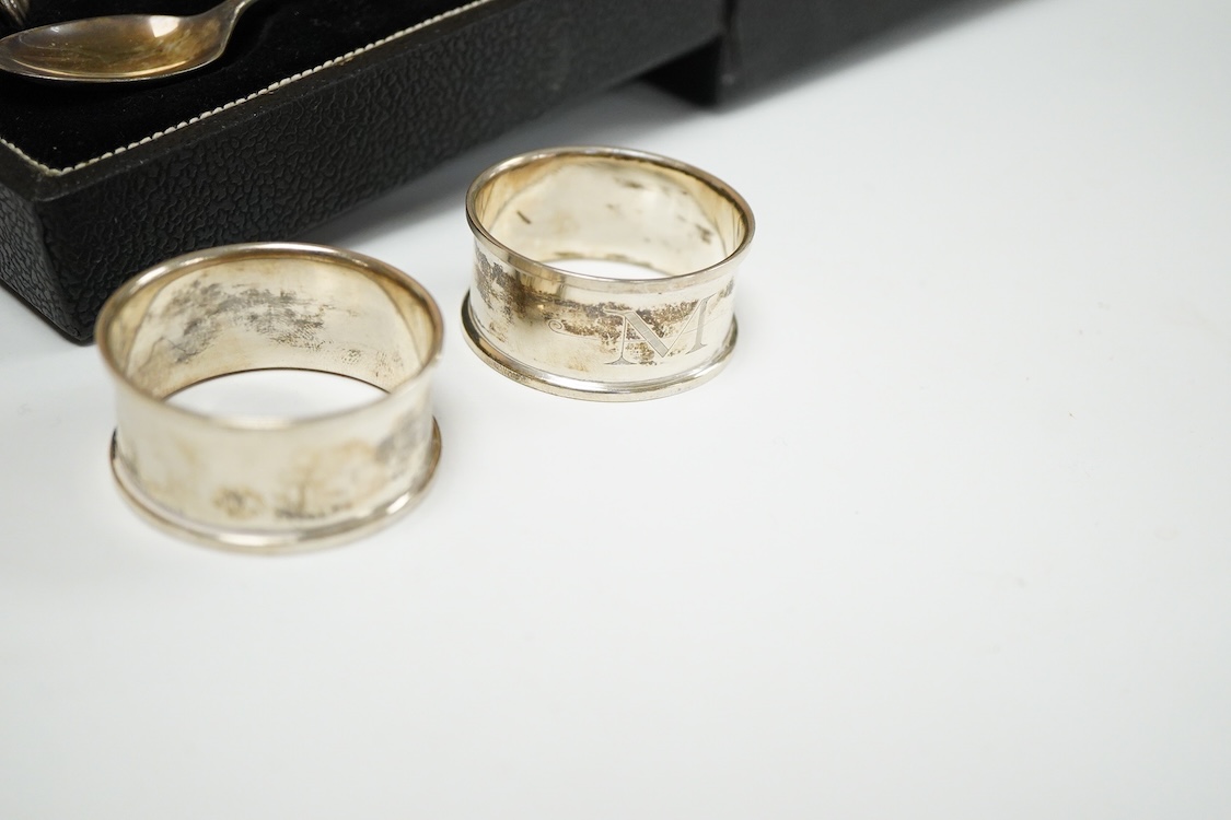 An Elizabeth II cased silver christening trio, Birmingham, 1959/60, together with three silver napkin rings.